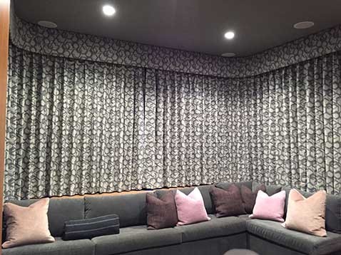 Custom curtains behind velvet corner sofa