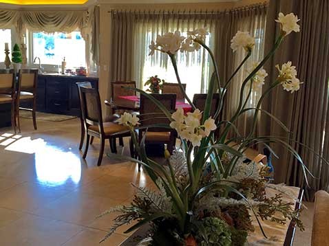 Elegant dinning room with custom draperies and flower display